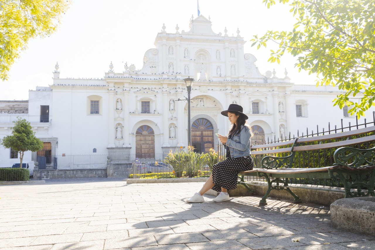 tourist traveling in colonial city-woman in the central park of Antigua Guatemala
