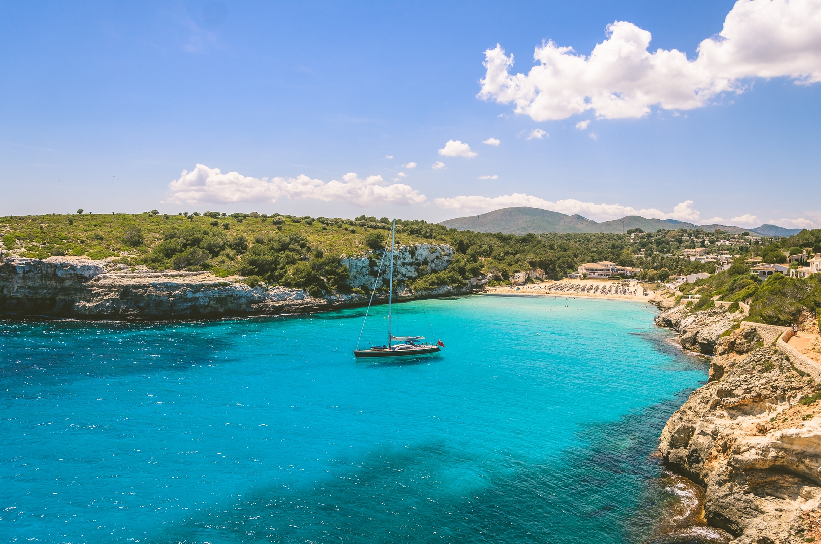 Wide view of Estany beach with a Boat, Mallorca, Palma de mallorca,  Spain
