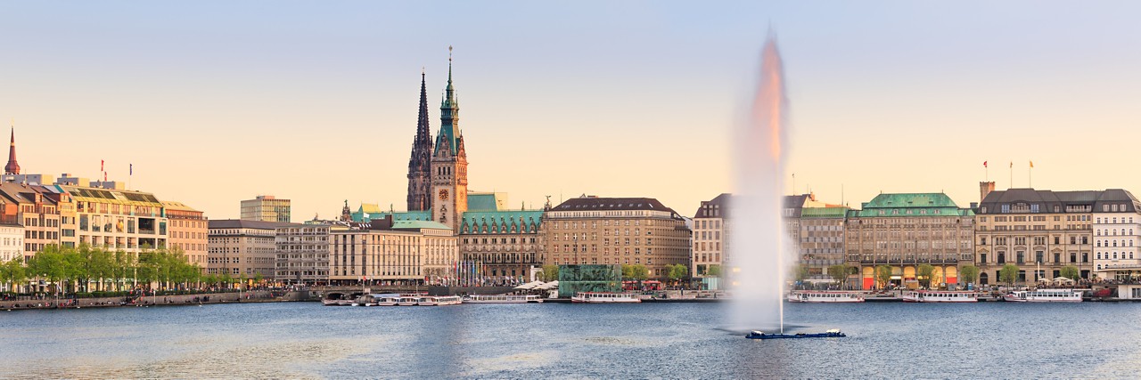 The Lake Binnenalster in Hamburg in Germany during spring time. In the foreground the famous Alster Lake fountain.