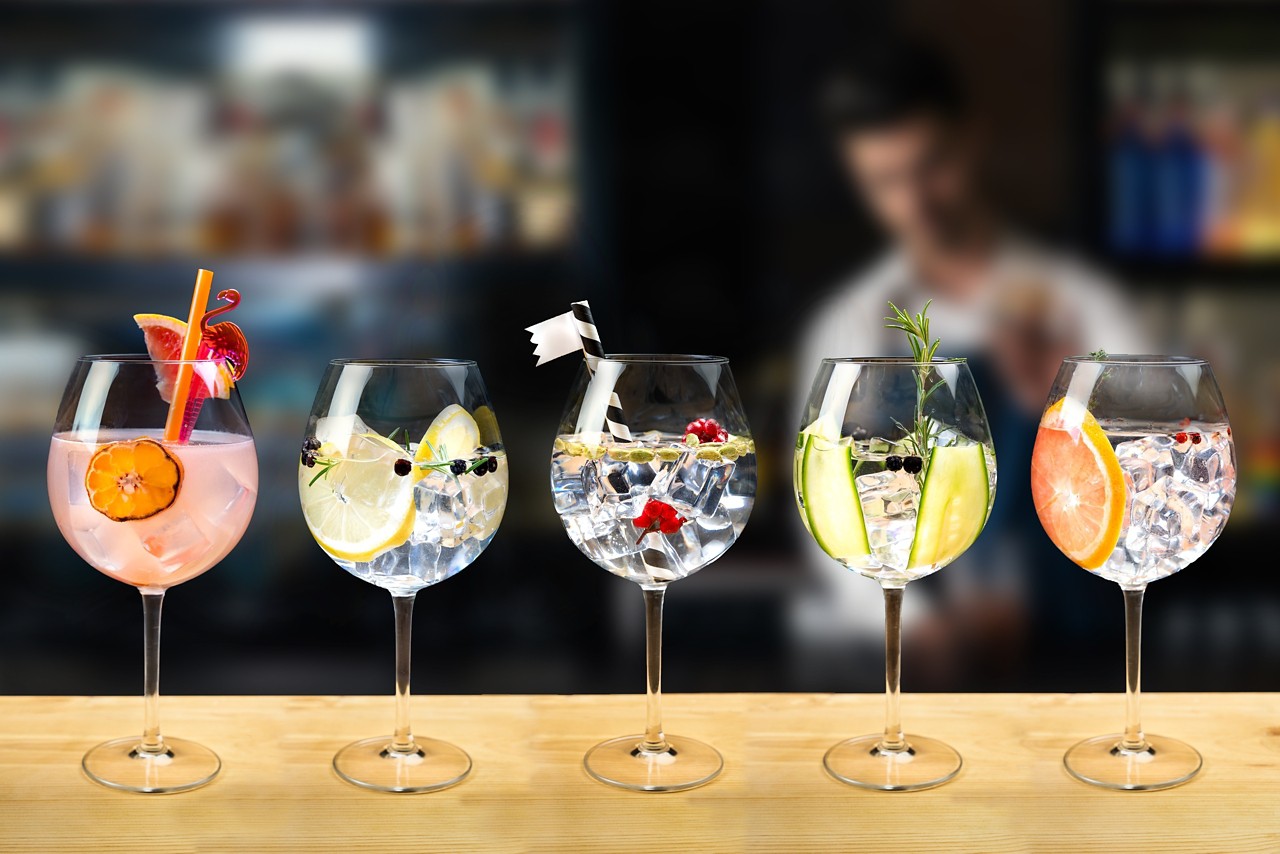 Gin and tonic mixed cocktail drinks various selection garnish bartender bar background fashion trendy