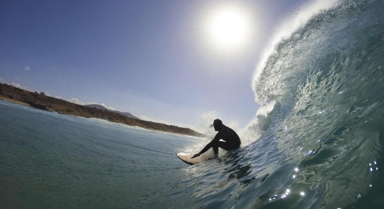 surfer in the tube of a wave