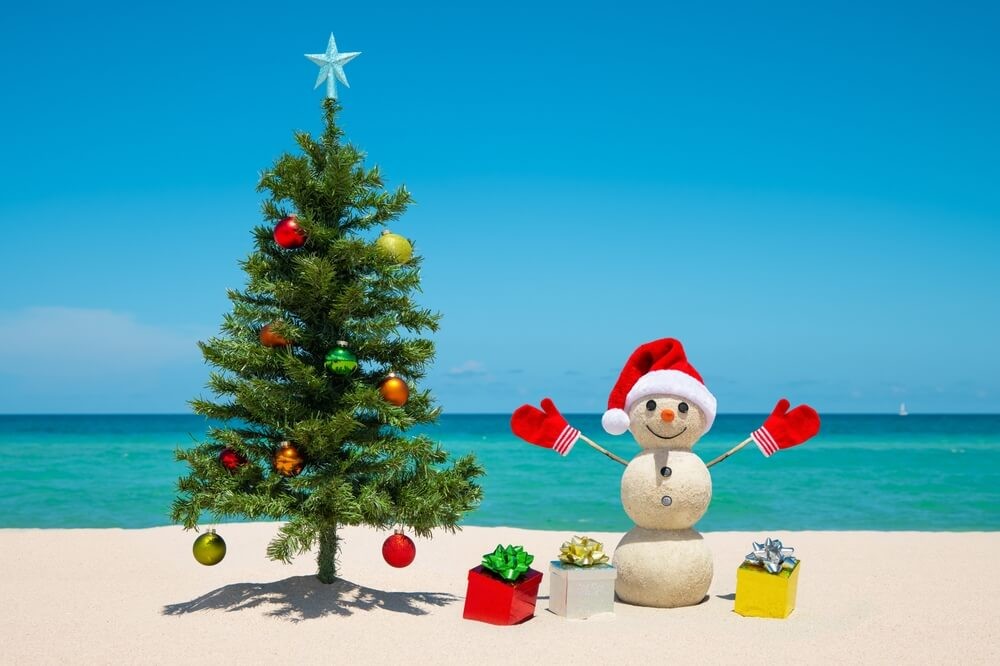 Playa del Carmen New Year’s Eve: A white sand beach with a Christmas tree and snowman