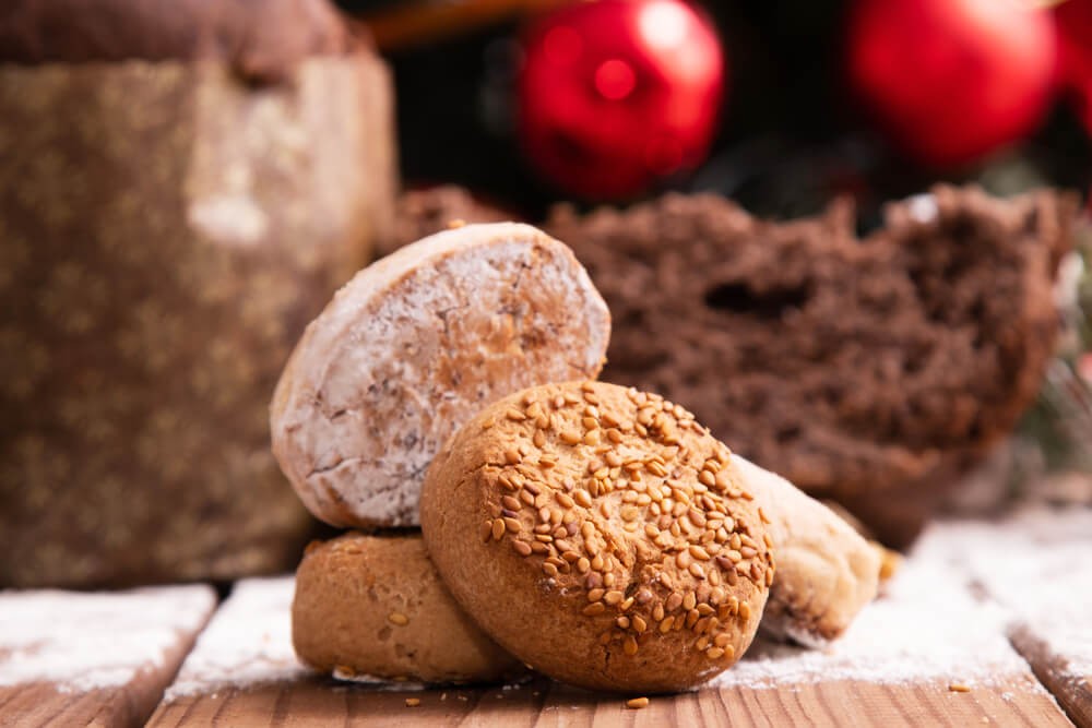 Mantecados: Round shortbread biscuits piled onto a wooden tray